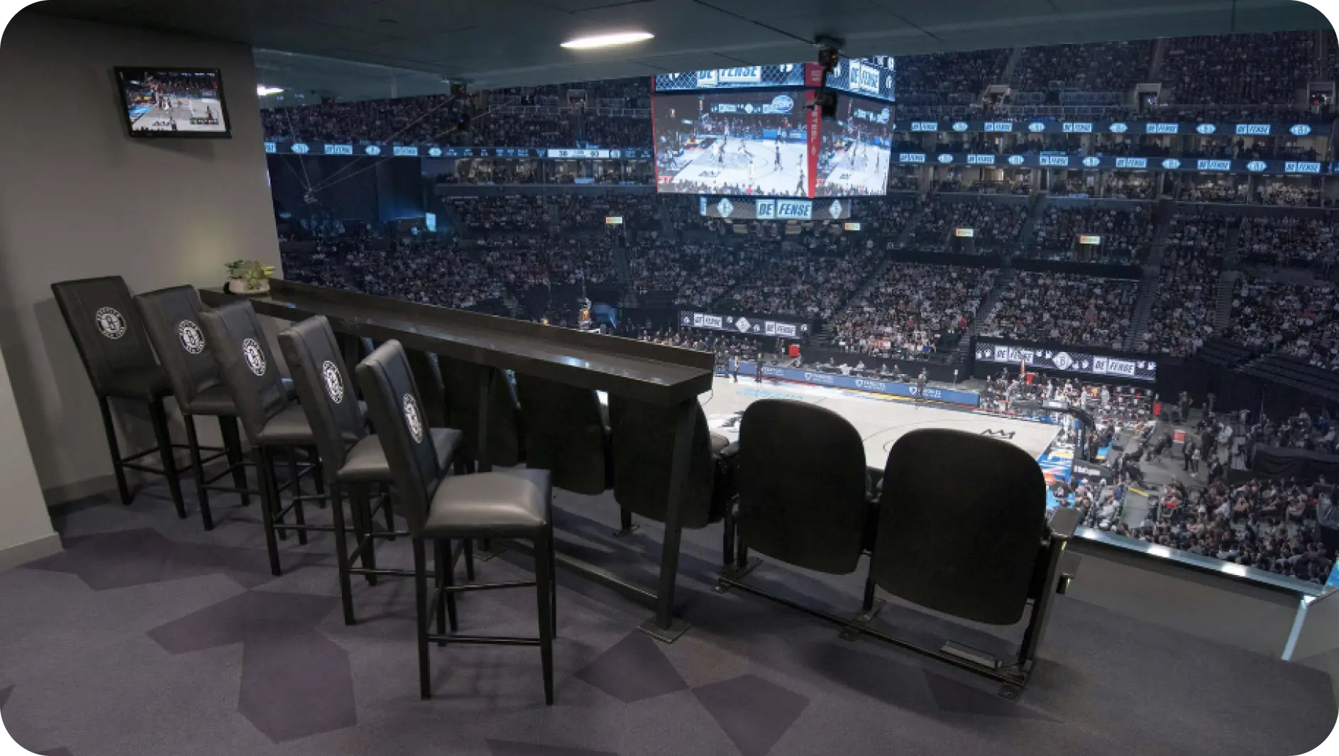 A perspective of the basketball court as seen from the spectator seats, showcasing the court layout and surrounding area.