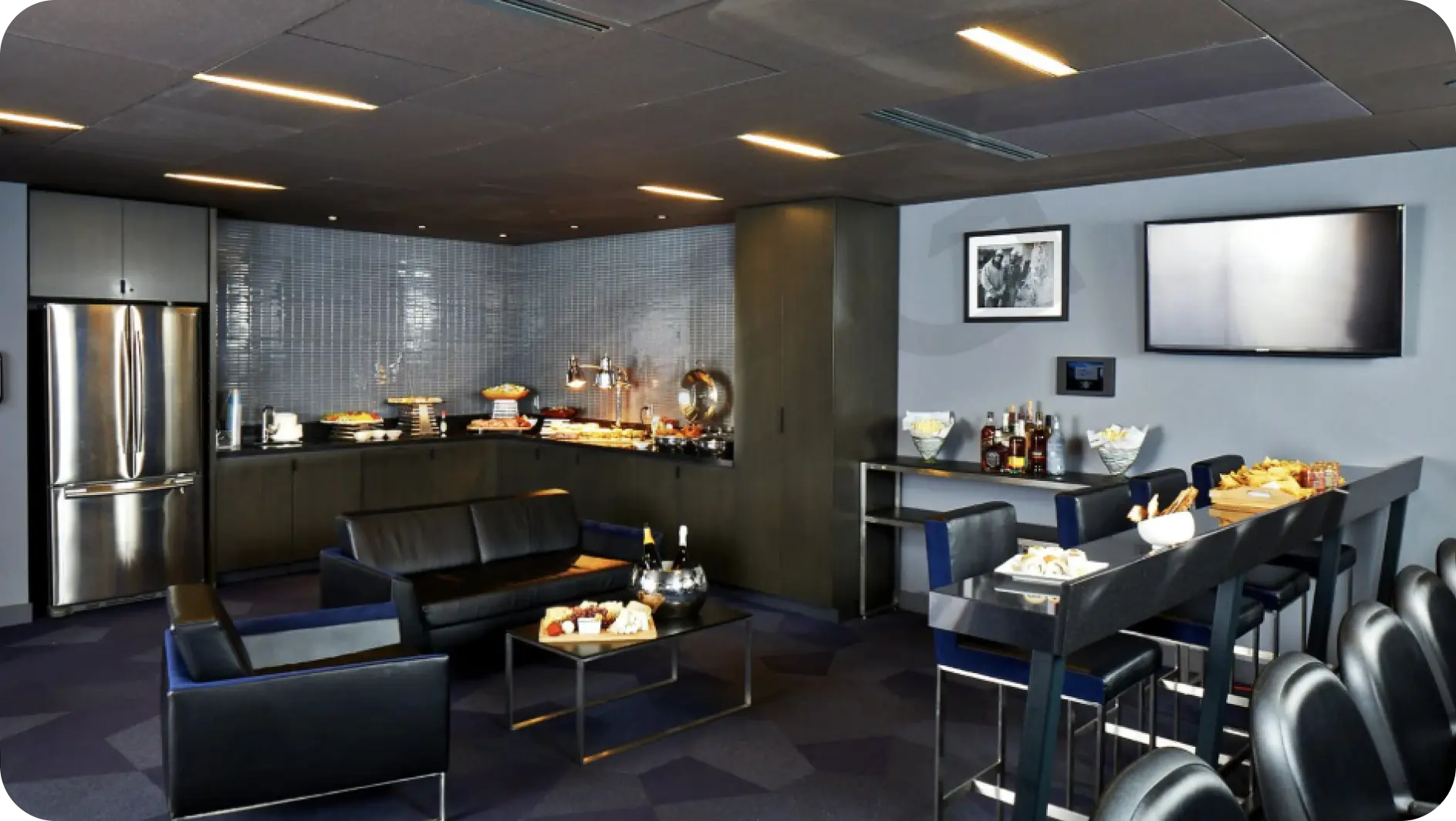 An inviting space with a bar, seating arrangements, and a television for viewing pleasure.