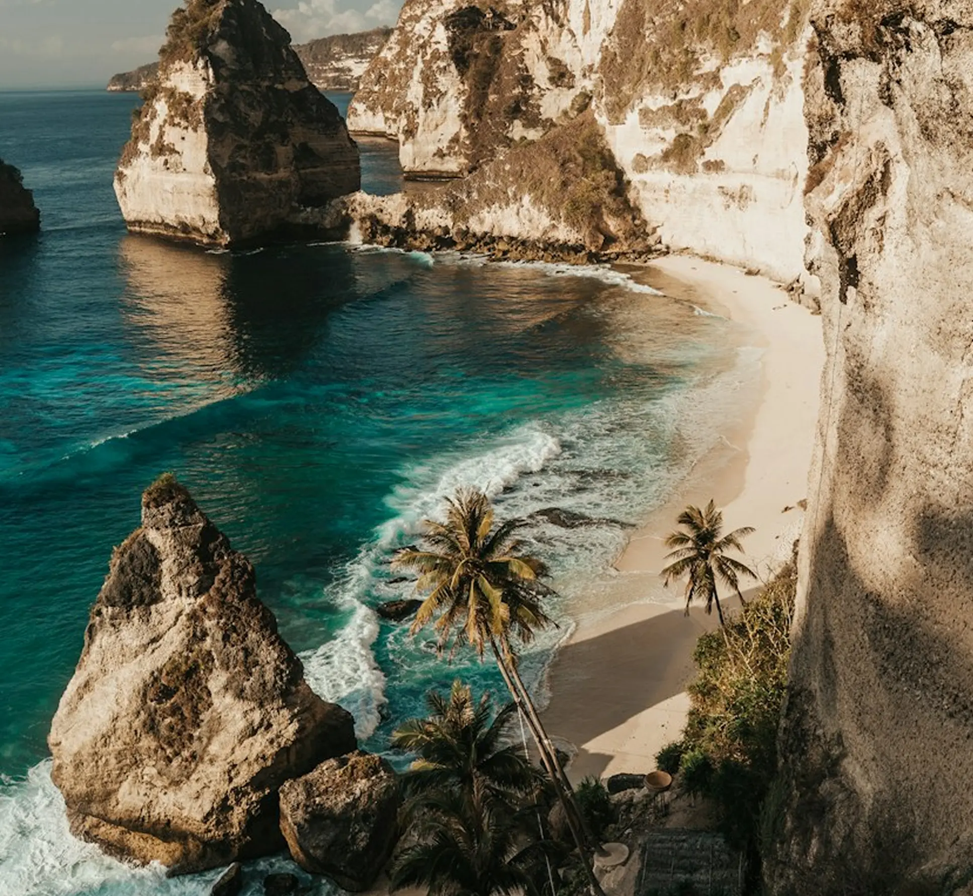 White camper van parked on a coastal cliff overlooking the ocean